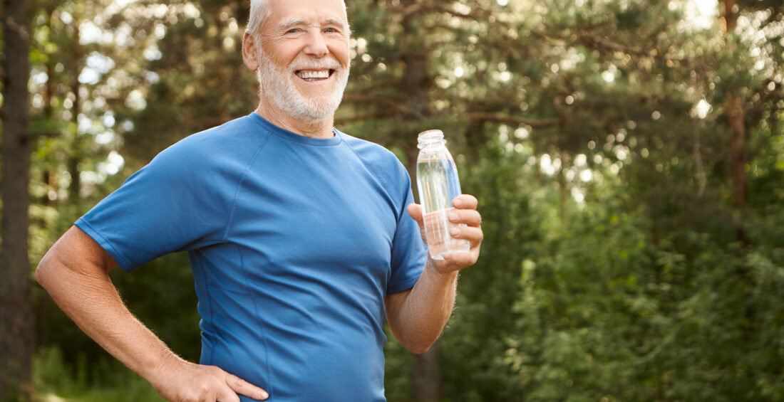 Portrait of joyful active Caucasian retired man with beard and b