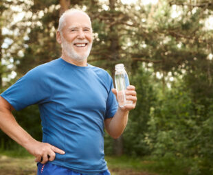 Portrait of joyful active Caucasian retired man with beard and b